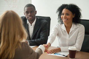 image of smiling on campus employer.  dark hair. 